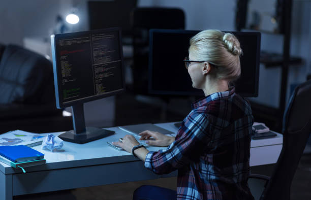 istock Cheerful IT girl working in the dark lighted room 673892086