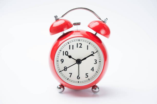 istock close up of a vintage red bell clock on white background 673895432