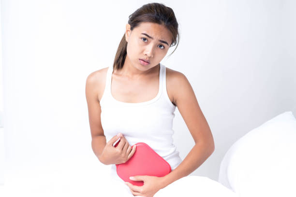 istock woman lying on the bad having stomach ache 673895458
