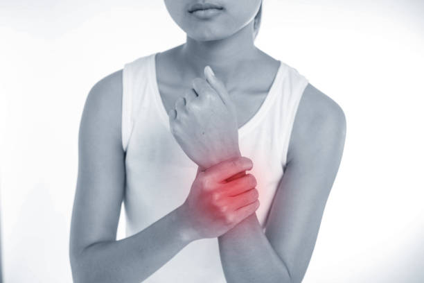 istock A young woman holding her painful wrist 673897710