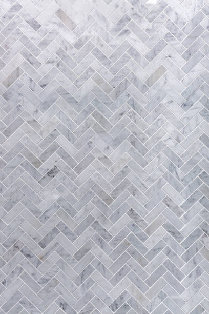 istock Background of grey and white marble tile in herringbone pattern 673897824