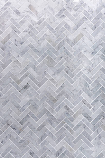Background of grey and white marble tile in herringbone pattern stock photo