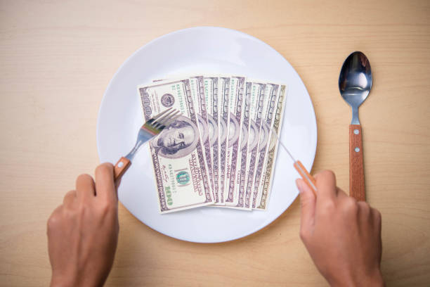 istock money in dish on the wood table 673898504