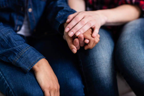 istock Midsection of female friends holding hands 673898824