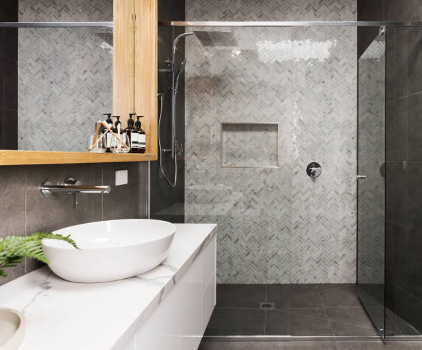 istock Marble mosaic herringbone tiled shower feature wall in a contemporary ensuite bathroom 673898830