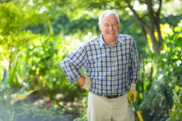 istock Senior man with equipment in garden 673899430