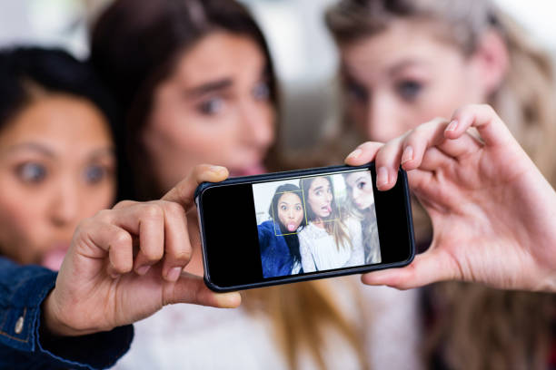 istock Young female friends taking selfie 673908296