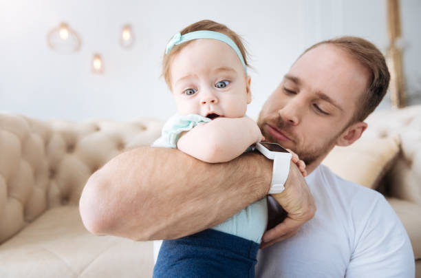 istock Delighted young father amusing his daughter at home 673909108