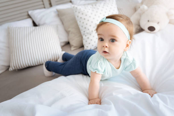 istock Cute surprised kid lying on the bed at home 673909198