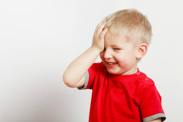 istock Happy kid boy making funny silly faces 673909550