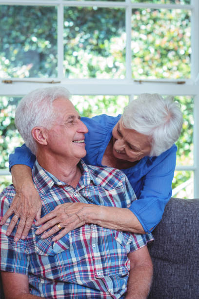 istock Happy wife embracing while looking at senior man 673914750