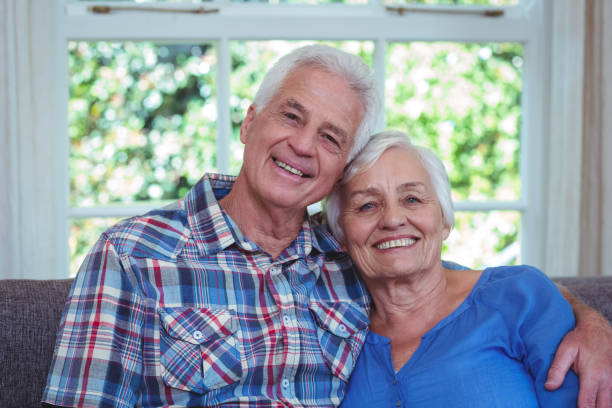 istock Happy senior couple sitting on sofa 673914916