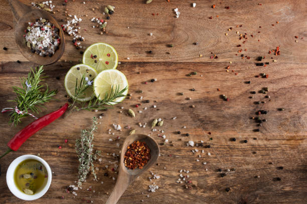 spices and herbs on rustic wood - zubereiten imagens e fotografias de stock