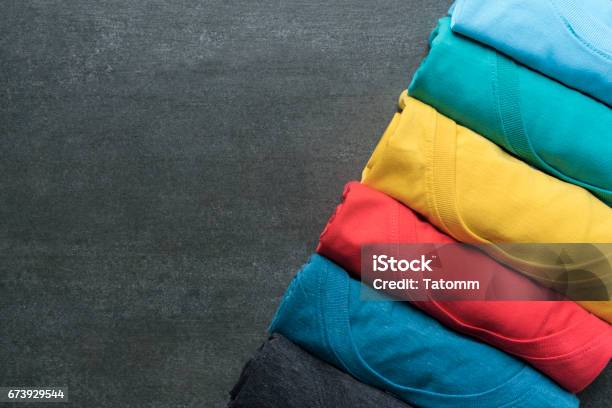 Close Up Of Rolled Colorful Clothes On Black Background Stock Photo - Download Image Now