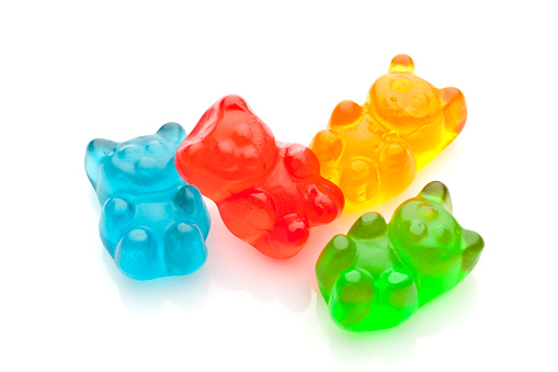 Horizontal shot of four gummy bears candies isolated on white background. DSRL high key studio photo taken with Canon EOS 5D Mk II and Canon EF 100mm f/2.8L Macro IS USM