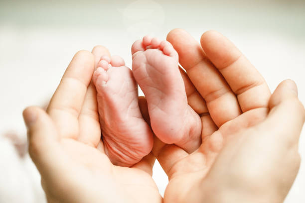 istock Father holding baby's feet 673932780