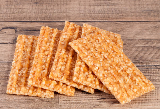 istock Sesame seed cookies on wooden plank. 673935906
