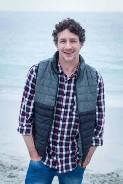 istock Confident mid adult man at sea hore 673936318