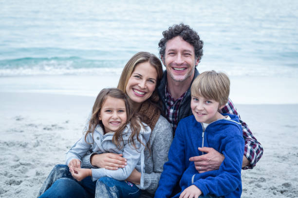 istock Happy family relaxing at sea shore 673937478