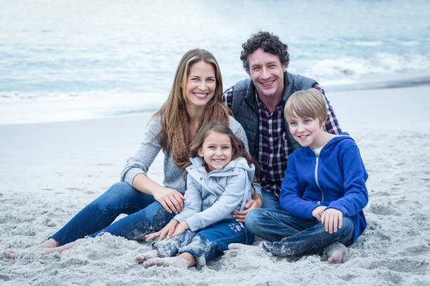istock Parents relaxing with children at sea shore 673939610