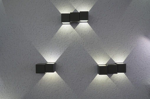 Electric lamps mounted on the wall of the house