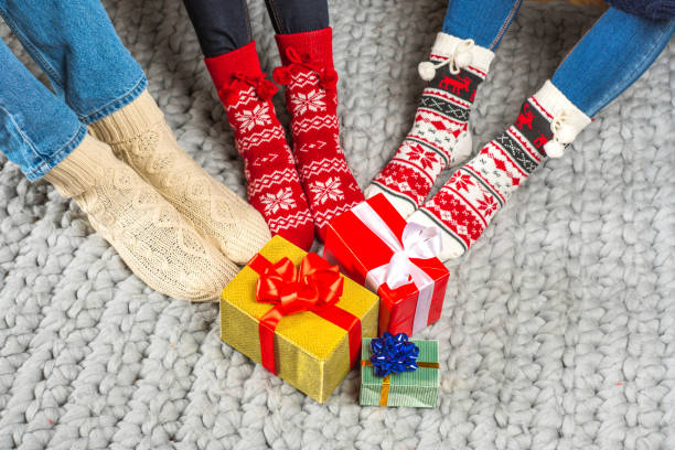 istock Legs in knitted socks and christmas presents 673966300