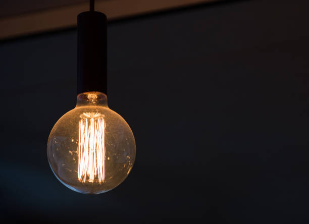 istock Decorative vintage style glowing light bulb, close-up view. 673966652
