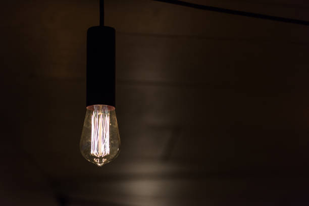 istock Decorative vintage style glowing light bulb, close-up view. 673967572
