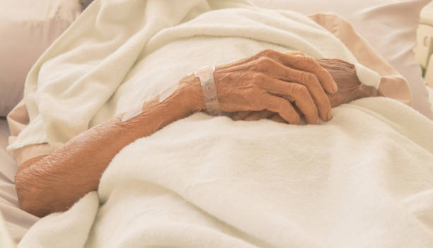 istock old Hand women on bed patient 673967822