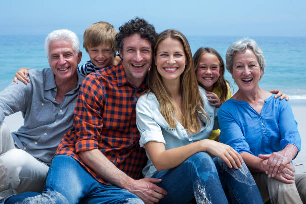 istock Cheerful multi-generation family relaxing at beach 673968184