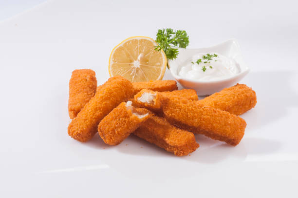 istock Breaded Fish Fingers with mayonnaise lemon & ketchup 673968508