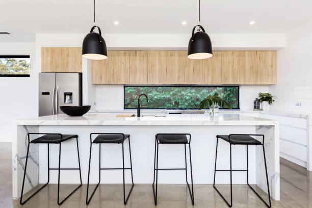 Large luxury Australian kitchen with marble island bench Large white luxury Australian kitchen with marble island bench recessed light stock pictures, royalty-free photos & images