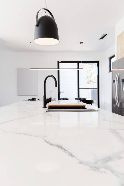 istock Carrera marble benchtop with black goose neck kitchen tap 673984404