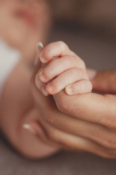 istock Baby holds mother's finger 673991208