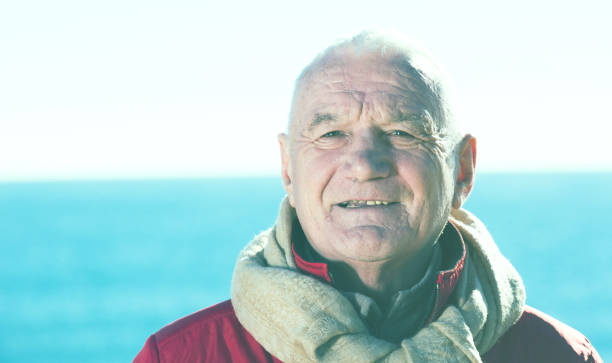istock Mature man walking by sea 673991596