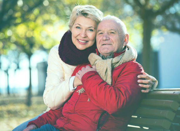istock Mature couple sitting in park 673991646