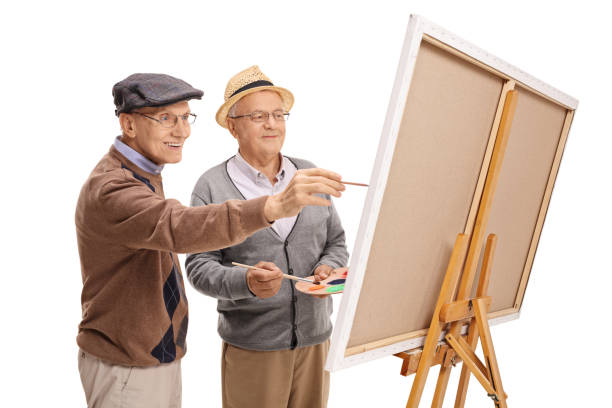 istock Two elderly men painting on a canvas 673997016