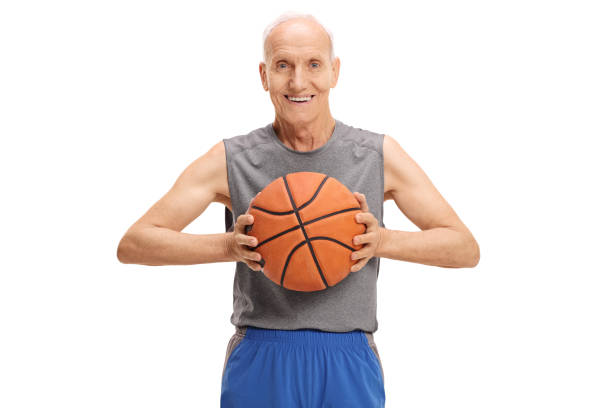 istock Senior with a basketball looking at the camera and smiling 673997086