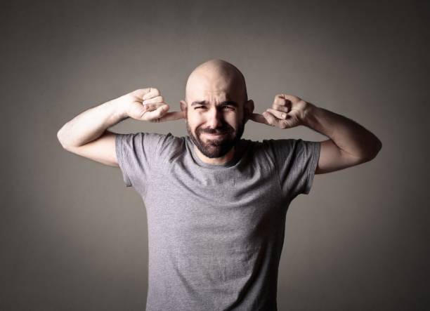 I don't want to hear it! Young man is trying to exclude the noise plastination photos stock pictures, royalty-free photos & images