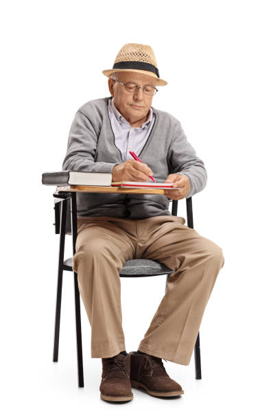 istock Senior sitting in a school chair and taking notes 673997132