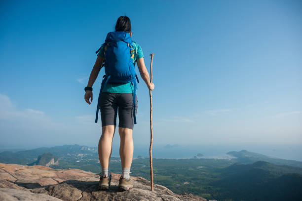 istock successful woman hiker enjoy the view on mountain peak cliff 673997480