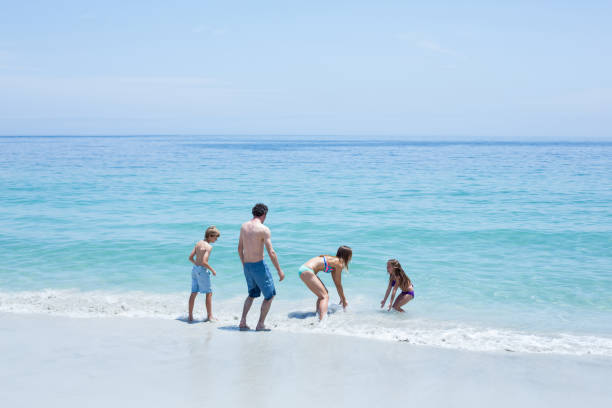 istock Cheerful family enjoying at beach 674000530