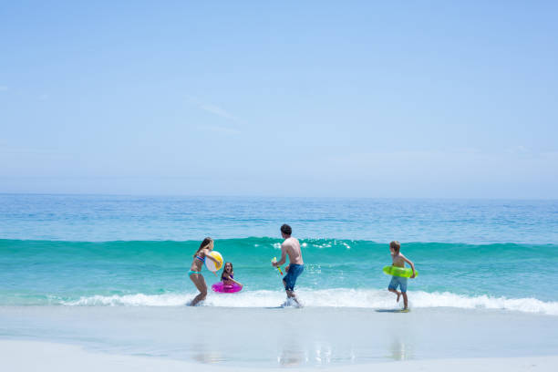 istock Family playing at sea shore 674005542