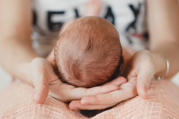 istock Happy mother holding a newborn child 674007114