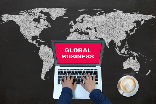 Blogging concept. A mouse cursor is clicking blog text on a globe textured with blue and white world map. Vertical composition with copy space. Clipping path is included.