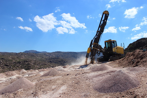 Rock driller working in open quarry