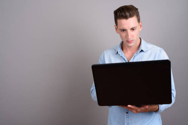 istock Studio shot of young handsome man against gray background 674016060