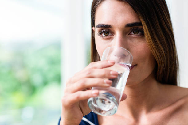 istock Young woman drinking water 674016166