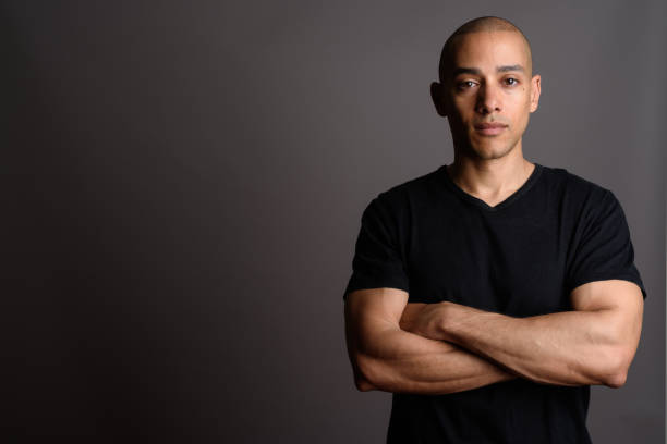 istock Studio shot of mature handsome bald man against gray background 674035468