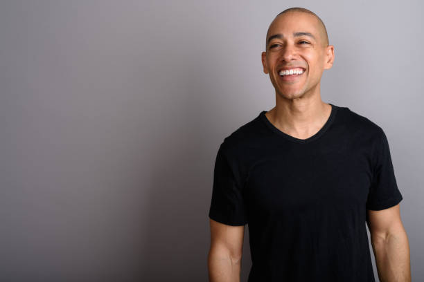 istock Studio shot of mature handsome bald man against gray background 674035876